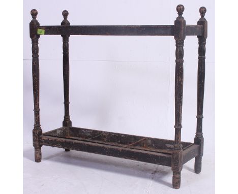 A Victorian oak stick stand - umbrella stand having sectioned body with trays to base having finial tops. H67 x W71 x D24 cm 