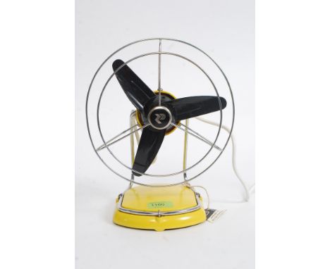 A vintage 1970's yellow retro Pifo table top desk fan with caged black fans. Measures: 30cm tall x 23cm diameter.