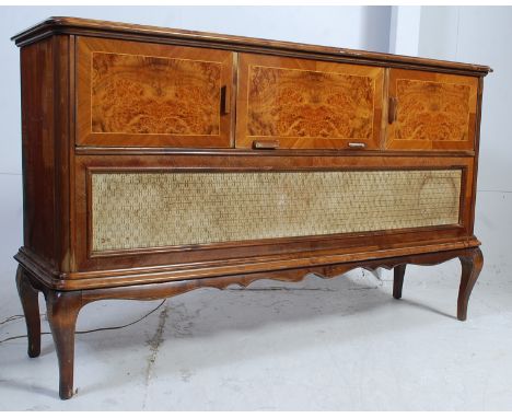A 1960's walnut inlaid Stereogram - hi-fi cabinet having shaped legs with inset Garrard deck, radio etc over fabric speaker t