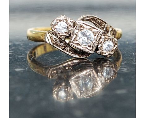 An 18ct gold vintage diamond ring having 3 inset stones on claw mounts. The diamonds approx 20pnts. Total weight 5.1g Ring si