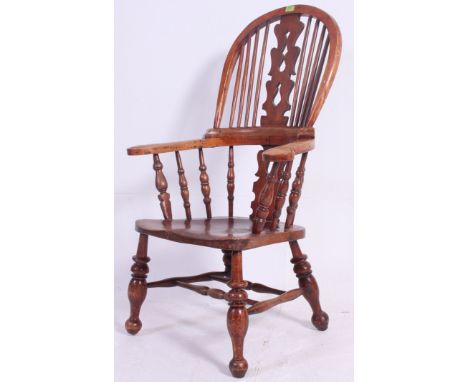 A Victorian yew wood and elm country windsor armchair. Raised on turned legs united by bobbin turned stretcher. Above a elm s