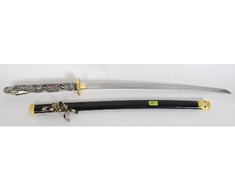 A replica ' Highlander ' sword having faux bone carved handle in the form of a dragon complete with scabbard. L110 cm 