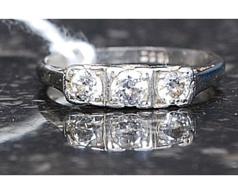 An 18ct white gold 3 stone diamond ring. The 3 central stones approx 20pnts in total. Stamped 18 to the shank. Total weight 2