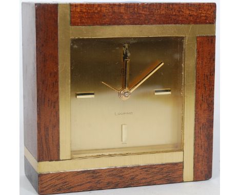 A retro vintage mid 20th century gilt brass and mahogany vintage alarm clock by Looping having additional markings to the fac