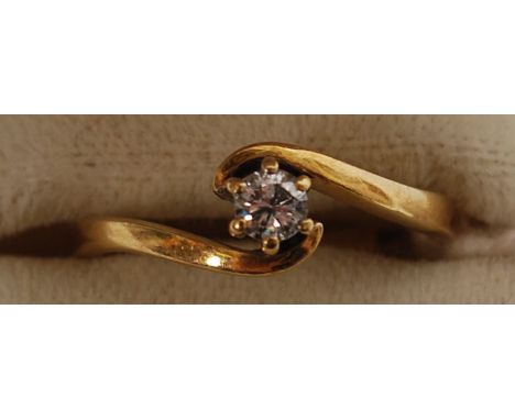 An 18ct gold and single stone diamond ring being suspension set having central diamond approx 15pts. Total weight 2.4g ring s