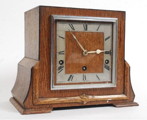 A good quality 1930s oak cased eight day mantel clock, the circular silvered dial set with Roman numerals inscribed Garrard B