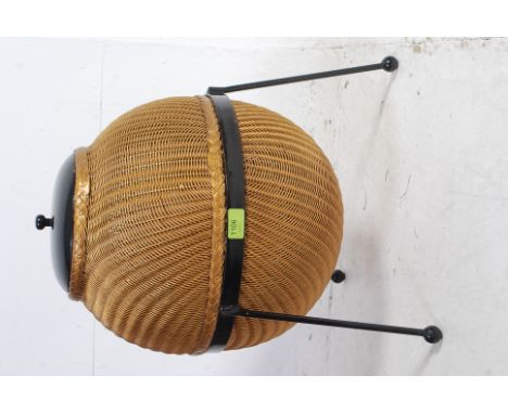 A Lloyd Loom Sputnik wicker linen basket, designed by Geoffrey Lusty, with wooden cover and painted metal tripod stand applie