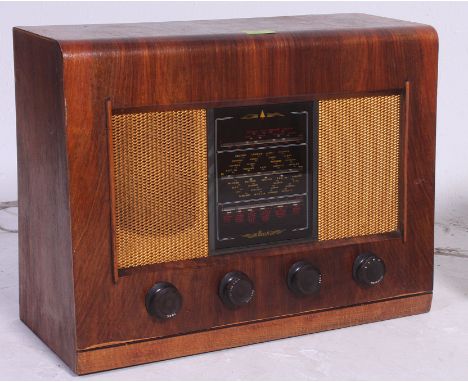 A vintage wooden cased valve radio Type AC 11 by Bush, bakelite dials and display panel to the front. Measures: 38 x 50 x 21.