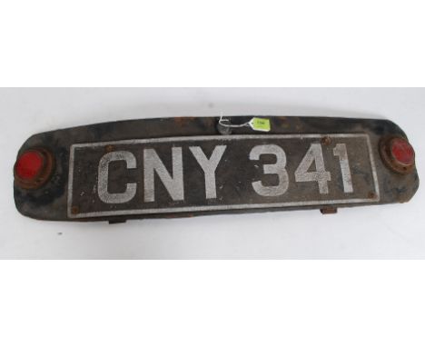 A mid 20th century vintage motoring interest registration plate CNY 341. Set to panel of car with red reflectors either side