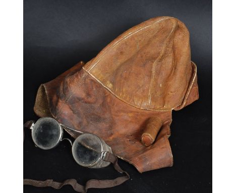 A vintage leather motorbike helmet ? along wih a pair of vintage goggles, both were used by the Vendors Grandfather when he w