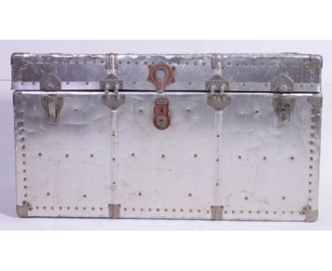 A large polished Aluminium steamer trunk, having notation to top and and a fully lined colourful Hippo interior. Measures: 54