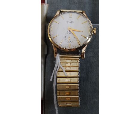 A vintage gentlemans Baume 17 Jewel 9ct gold hallmarked wristwatch set on a rolled gold flex strap. The face with baton numer