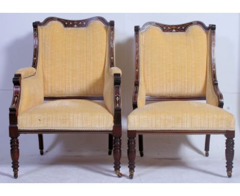 A Pair of ( 2 ) Victorian rosewood, mahogany and marquetry inlaid salon armchairs. Raised on turned legs with ceramic castors