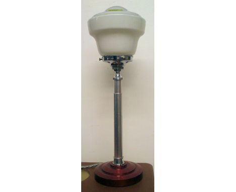 A vintage Art Deco lamp, standing on original stepped circular base, with shaped white glass globe to top.  Measures: 49 tall