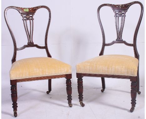 A Pair of ( 2 ) Victorian rosewood, mahogany and marquetry inlaid nursing chairs. Raised on turned legs with ceramic castors,