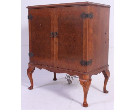 A Vintage Queen Anne walnut cased Dynatron hi-fi stereo system being raised on shaped legs. Measures: 96 x 78 x 48 