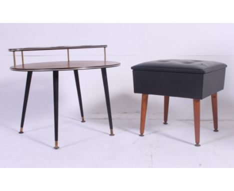 A vintage 1950's teak wood drink / cocktail table raised on ebonised supports with circular drop centre top have bottle reces