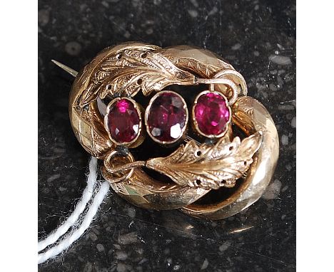 A 9ct gold and amethyst ladies brooch. The three central stones with leaf surrounds. Unmarked, tests as 9ct