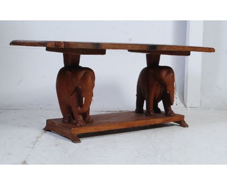 A vintage 1950's hardwood ceylon - Sri Lanka coffee table. The square top with inlaid palm tree motif set over legs in the fo