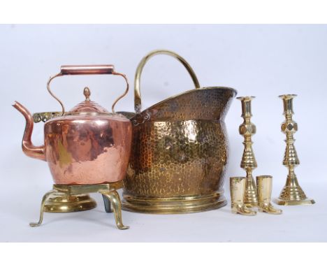 A collection of vintage brass wares to include a coal scuttle along with a raised trivet stand, copper kettle , 2 good candle