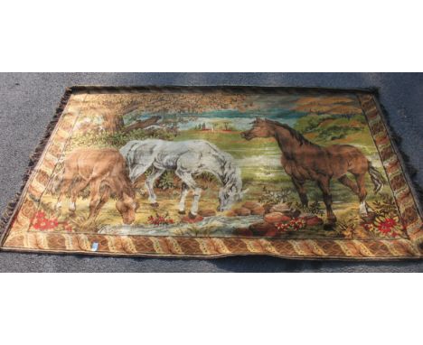 A wall hanging tapestry rug depicting Horses and other animals in a naturalistic setting