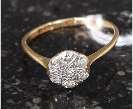 An 18ct gold and diamond ring with flower head having inset diamonds surrounding a star. Total weight 1.5