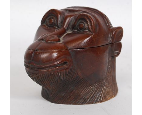 A Victorian style tea caddy / tobacco jar carved hardwood container in the form of a monkeys head. Hinged lid revealing inter
