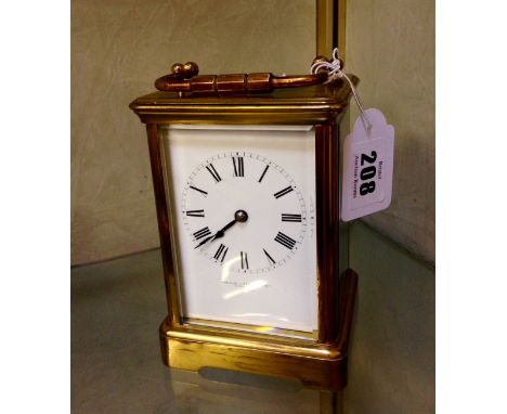 A French carriage clock by R.C., striking on gongs, the white enamel dial bearing the name of ‘Howell James Ltd, to the Queen