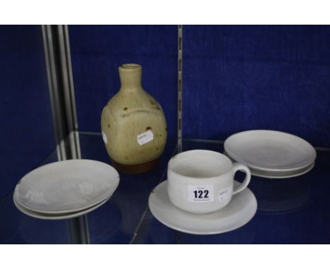 Dame Lucie Rie D.B.E (1902-1995), a tea cup and five saucers, off white glazed, each marked, the saucers 14cm diameter (each 