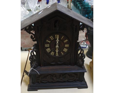 A Swiss cuckoo clock, with leaf carvings, 46cm high 
