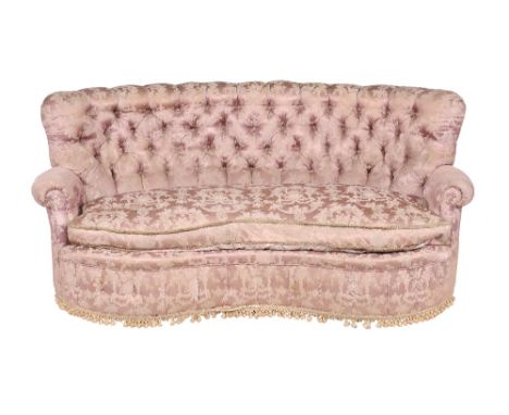 A pink damask button back upholstered kidney shaped sofa, early 20th century, in the manner of Howard & Sons, the curved back