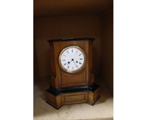 An early 20th Century ebonised and walnut cased mantel clock, 39cm high  