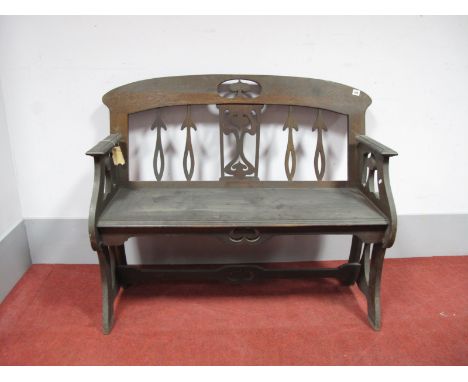 An Art Nouveau Oak Bench, with stylised flower pierced splat, shaped arms, solid seat with moulded edge, on shaped legs, 93cm