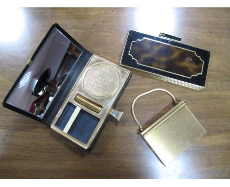 A Volupté (USA) Gilt Metal Compact Carry-All, with lipstick, powder and cigarette compartments and mirror, mesh handle; a bla