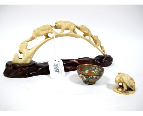 A Late XIX Century Japanese Ivory Bridge Carved with Five Monkeys, hardwood stand, 24cm long; A Japanese Ivory Netsuke, carve