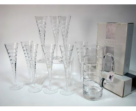 A Set of Nine Carr's of Sheffield Hand Cut Lead Crystal 'Swirl' Champagne Flutes, 27cm high (part boxed); A Matching Water Ju