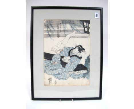 A Late XIX Century Japanese Woodcut Print, the seated lady holding a scroll beside branches and a lantern, framed and glazed,
