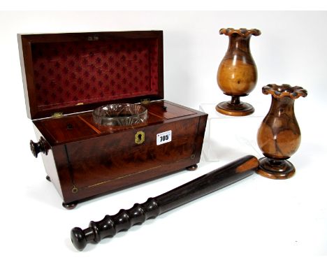 An Early XIX Century Mahogany Tea Caddy, of sarcophagus form with brass inlay and turned handles, raised on bun feet, opening