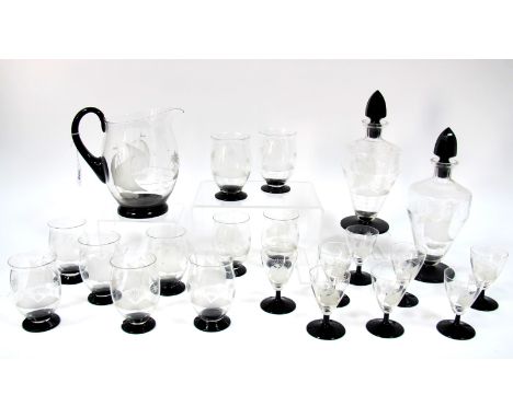 A 1930's Art Deco Glass Lemonade Set, the clear bodies etched with boats by a tropical island, black bases and handle, with a
