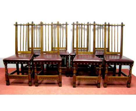 A Set of Eight Nigel Griffiths Stick Back Dining Chairs, the hide seats with button decoration, on turned and block supports,