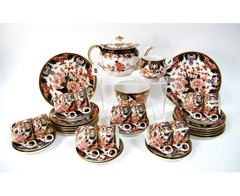 A Late XIX Century Derby Porcelain Tea Service, decorated in Imari pattern 383, with flowering trees and shrubs, date code fo