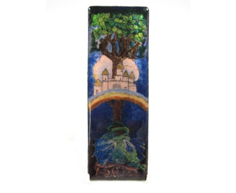 An Arts & Crafts Enamel Plaque, of rectangular form, depicting a fantasy castle and rainbow in an apple tree with guarding dr