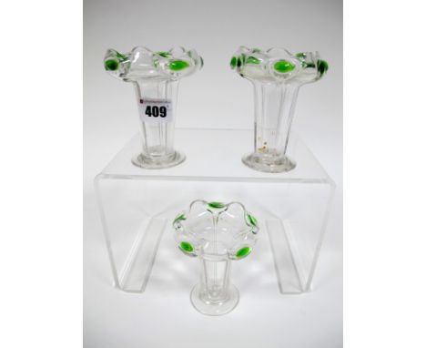 A Set of Three Art Nouveau Glass Vases, of fluted tapered form with outcurved wavy rim with green roundels, raised on circula