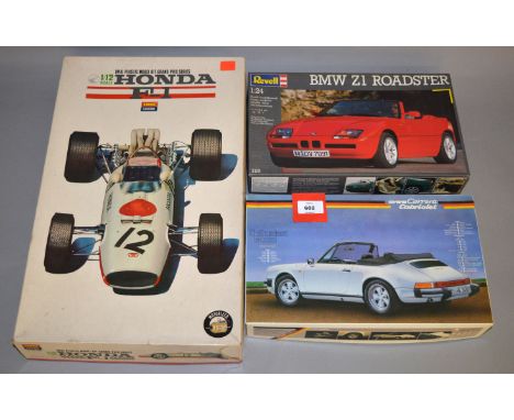 Six plastic model kits, all cars, by Bandai, Tamiya and similar. Some appear complete and unstarted but others built. (6)