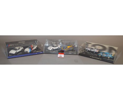 Minichamps. Two Porsche model sets, each containing two diecast models in 1:43 scale including a Tribute to Mark Donohue Set,