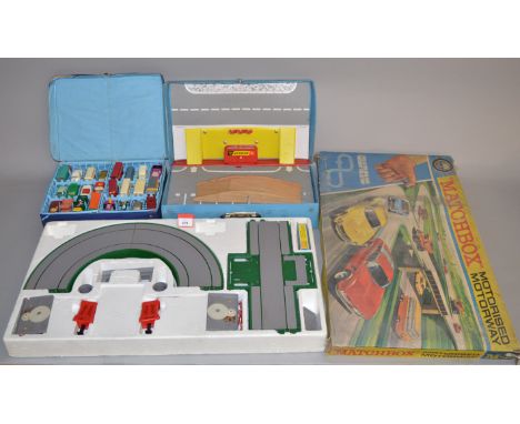A boxed M-2 Matchbox Motorised Motorway, F,unchecked for completeness, together with a Matchbox 1-75 Carry Case containing fo