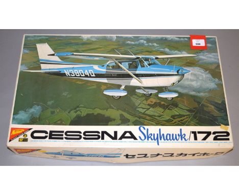 Three large plastic model kits, all aircraft: Tamiya 1:32 scale Grumman 14A Tomcat; Nichimo Cessna Skyhawk 172; Hasegawa 1:32