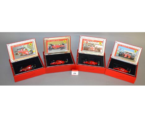 Four Hot Wheels diecast Ferrari models in 1:43 scale including a 1983 126 C3, a Brazil GP 1985 156-85, 1987 F1, and a 1990 64