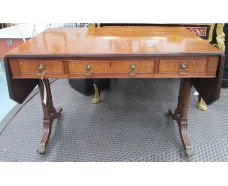 SOFA TABLE, Regency mahogany with canted corner hinged top above three drawers on turned end supports with brass paw caps and