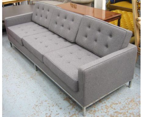 SOFA, with grey felt upholstery on polished metal supports, 230cm W x 78cm D x 78cm H. 